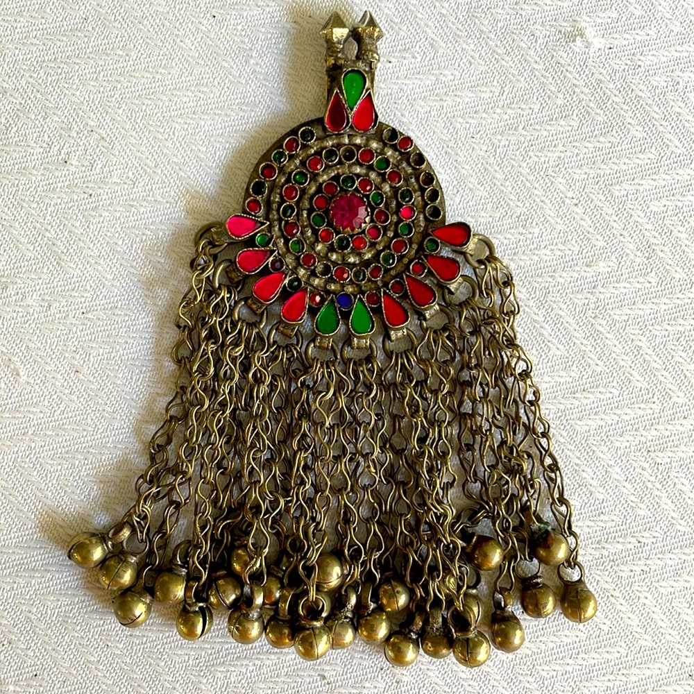 Rhinestone encrusted pendant with miniature bells hanging from brass chain links